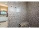 Spacious walk-in shower with a built-in bench and mosaic tile at 10751 E Cactus View Cir, Gold Canyon, AZ 85118