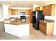 Kitchen boasts granite countertops and oak cabinets at 11028 E Nichols Ave, Mesa, AZ 85209