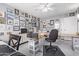 Spacious home office with dual desks and gallery wall at 11815 N Rio Vista Dr, Sun City, AZ 85351