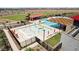 Aerial view of a community pool area with a water playground and lounge chairs at 12391 E Bahia Ct, Florence, AZ 85132