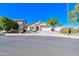 Single-story house with stone accents, two-car garage, and landscaped yard at 15896 N 182Nd Ave, Surprise, AZ 85388