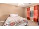 Bedroom with floral bedding and ceiling fan at 23607 N El Frio Ct, Sun City, AZ 85373