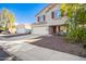 Two-story house with a beige exterior, red shutters, and a two-car garage at 23607 N El Frio Ct, Sun City, AZ 85373