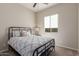 Bright bedroom featuring a bed, nightstand, and window at 2949 N Acacia Way, Buckeye, AZ 85396