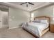 Primary bedroom with king-size bed and ensuite bathroom at 2949 N Acacia Way, Buckeye, AZ 85396