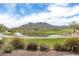Serene golf course with a pond and mountain backdrop at 2949 N Acacia Way, Buckeye, AZ 85396
