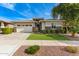 Single-story home with a three-car garage, manicured lawn, and brick facade at 2949 N Acacia Way, Buckeye, AZ 85396
