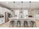 Modern kitchen with white shaker cabinets, stainless steel appliances, and a large island at 2949 N Acacia Way, Buckeye, AZ 85396