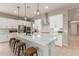 Modern kitchen with white shaker cabinets, stainless steel appliances, and a large island at 2949 N Acacia Way, Buckeye, AZ 85396