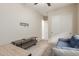 Home office with a sofa, desk, and ample storage at 2949 N Acacia Way, Buckeye, AZ 85396