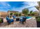 Relaxing patio with comfortable seating, fire pit, and easy access to the refreshing pool at 2949 N Acacia Way, Buckeye, AZ 85396