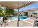 Enjoy this refreshing pool with a pergola, outdoor kitchen, and brick accents at 2949 N Acacia Way, Buckeye, AZ 85396