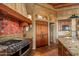 Bright kitchen features a professional range and custom wooden cabinetry at 41731 N Stone Cutter Dr, Scottsdale, AZ 85262