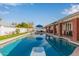 Inviting backyard oasis featuring a sparkling pool, diving board, and ample patio space at 5038 W Echo Ln, Glendale, AZ 85302