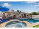 Stunning backyard with a refreshing pool, a relaxing spa, and a covered patio at 5038 W Echo Ln, Glendale, AZ 85302