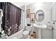 Clean bathroom with pedestal sink, tub, and shower at 10205 W Royal Oak Rd, Sun City, AZ 85351