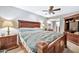 Main bedroom with a king-size bed, wood furniture, and ceiling fan at 10205 W Royal Oak Rd, Sun City, AZ 85351