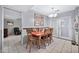 Bright dining area with wooden table and chairs near kitchen at 10205 W Royal Oak Rd, Sun City, AZ 85351