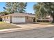 House exterior featuring a white garage door and driveway at 10205 W Royal Oak Rd, Sun City, AZ 85351