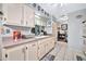 Kitchen boasts white cabinets, a double sink, and a spacious layout at 10205 W Royal Oak Rd, Sun City, AZ 85351