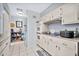 Kitchen with white cabinets, built-in appliances, and ample counter space at 10205 W Royal Oak Rd, Sun City, AZ 85351