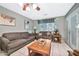 Living room with tiled floors, two sofas, and a coffee table. Access to backyard at 10205 W Royal Oak Rd, Sun City, AZ 85351