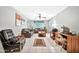 Spacious living room with tiled floors, comfortable seating, and a workspace at 10205 W Royal Oak Rd, Sun City, AZ 85351