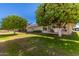 Backyard with grass, fruit trees, and a patio at 10728 W Cheryl Dr, Sun City, AZ 85351