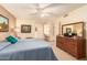 Main bedroom with ensuite access and large dresser at 10728 W Cheryl Dr, Sun City, AZ 85351