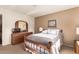 Bedroom with a dresser, mirror, and wooden bed frame at 10728 W Cheryl Dr, Sun City, AZ 85351