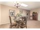 Bright dining room featuring a glass table and chandelier at 10728 W Cheryl Dr, Sun City, AZ 85351