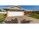 House exterior with a white garage door and a large driveway at 10728 W Cheryl Dr, Sun City, AZ 85351