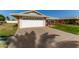 House exterior with a white garage door and a large driveway at 10728 W Cheryl Dr, Sun City, AZ 85351