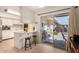 Kitchen with island and sliding doors leading to backyard at 10728 W Cheryl Dr, Sun City, AZ 85351