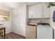 Laundry room with washer, dryer, and ample storage at 10728 W Cheryl Dr, Sun City, AZ 85351