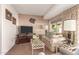 Cozy living room featuring a comfy sofa and large TV at 10728 W Cheryl Dr, Sun City, AZ 85351