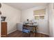 Small office space with a desk, chair, and mini-fridge at 10728 W Cheryl Dr, Sun City, AZ 85351
