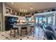 Spacious kitchen with an island, white cabinets, and black appliances at 10773 S Xavier Ct, Goodyear, AZ 85338