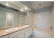 Bathroom with double sinks, bathtub, and a large mirror at 11515 N 91St St # 245, Scottsdale, AZ 85260