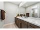 Modern bathroom with single sink, quartz countertop and dark wood cabinets at 11946 E Cavedale Dr, Scottsdale, AZ 85262
