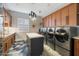 Bright laundry room with modern appliances and an island at 11946 E Cavedale Dr, Scottsdale, AZ 85262