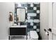 Modern powder room with a stylish sink, geometric tile, and a toilet at 11946 E Cavedale Dr, Scottsdale, AZ 85262