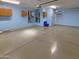 Large garage with light blue walls and epoxy flooring at 14632 W Ganado Dr, Sun City West, AZ 85375