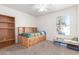 Charming bedroom with wood bed frame and plenty of storage at 1480 E Tremaine Ave, Gilbert, AZ 85234