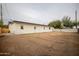 View of the home's back exterior, showing a large backyard at 1501 W Grovers Ave, Phoenix, AZ 85023