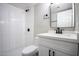 Modern bathroom with white vanity, toilet, and shower at 1501 W Grovers Ave, Phoenix, AZ 85023