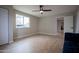 Bright bedroom with wood-look floors and a window at 1501 W Grovers Ave, Phoenix, AZ 85023