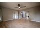 Bedroom with hardwood floors, ceiling fan, and open view of kitchen at 1501 W Grovers Ave, Phoenix, AZ 85023