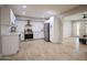 Open concept kitchen with white cabinets, stainless steel appliances, and a view into the living area at 1501 W Grovers Ave, Phoenix, AZ 85023