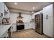Modern kitchen with white shaker cabinets, stainless steel appliances, and quartz countertops at 1501 W Grovers Ave, Phoenix, AZ 85023